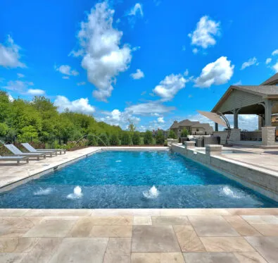 Poolcraft Ltd - Inground outside pool with a sunken shelf that has pool jets