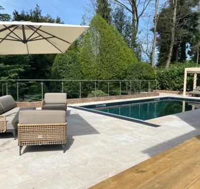 PoolCraft Ltd - Luxury outdoor swimming pool with Egyptian limestone surrounds and Crocus green mosaic