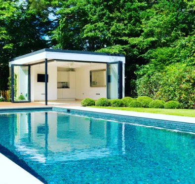 Poolcraft Ltd - view of an inground outside pool with luxury pool house