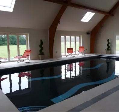 PoolCraft Ltd - Luxury Indoor Pool with corner pool steps and geometric patterned bottom